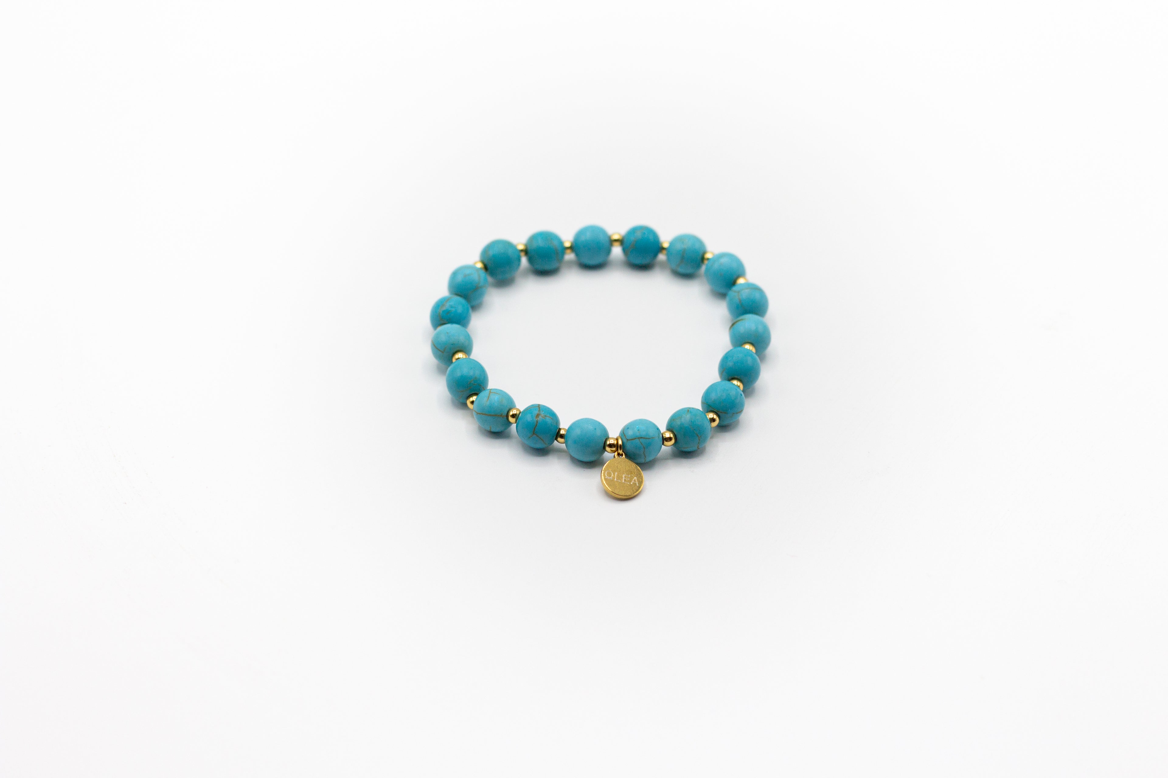 pulsera elástica piedra natural turquesa y separadores de acero inoxidable color oro